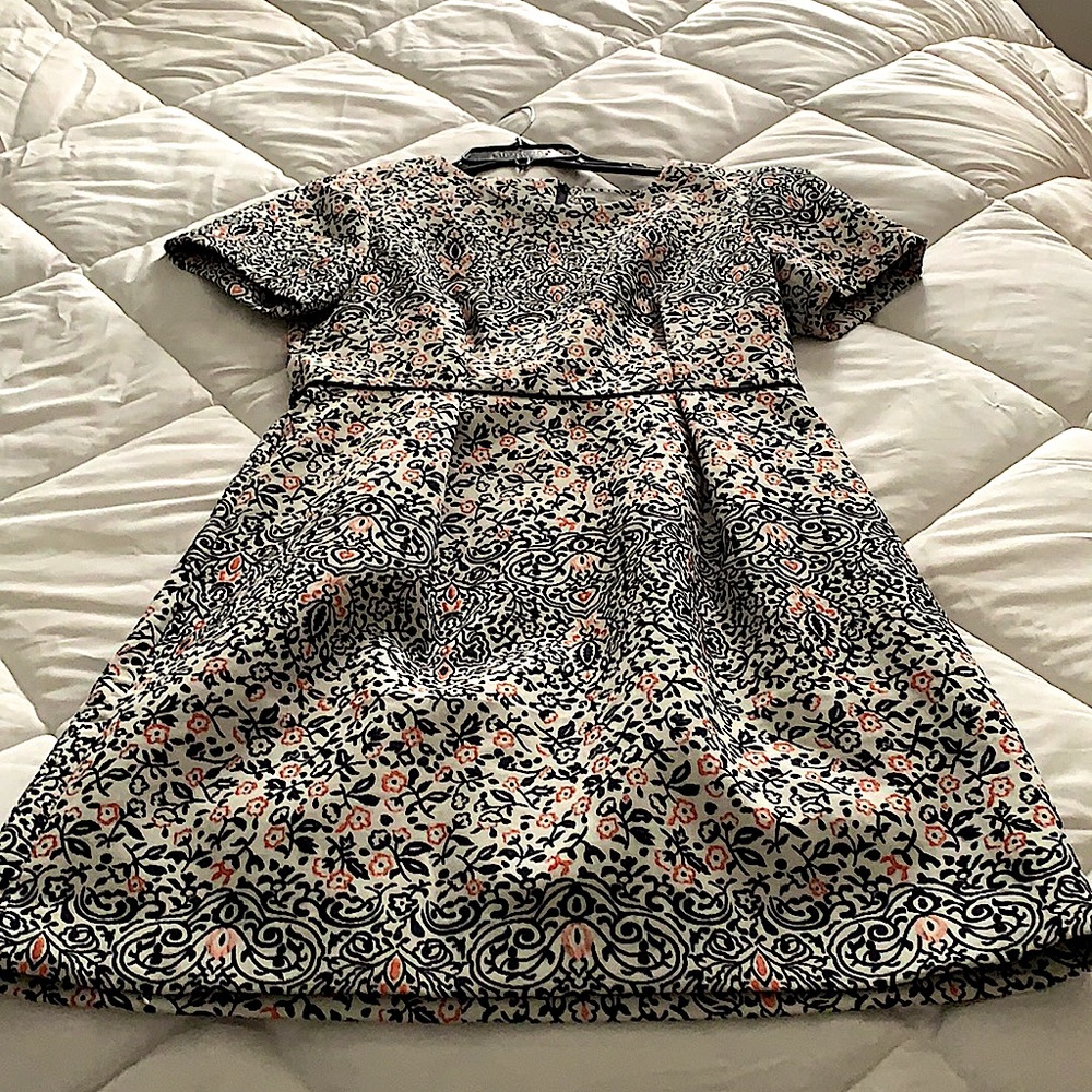 Cute cocktail dress with black and orange embroidery.